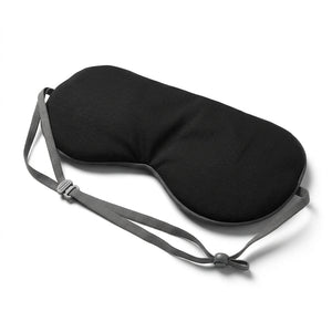Masque de nuit occultant noir Velmi avec bandeau élastique gris ajustable, sur fond blanc.